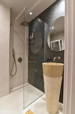 a bathroom with a sink and a glass shower at Fos Apartment - Ippokratous 2BDR Central Flat in Athens