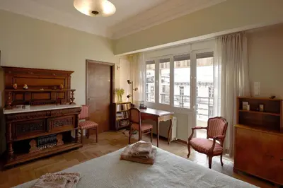 a bedroom with a piano and a table and chairs at Park View Penthouse in Athens