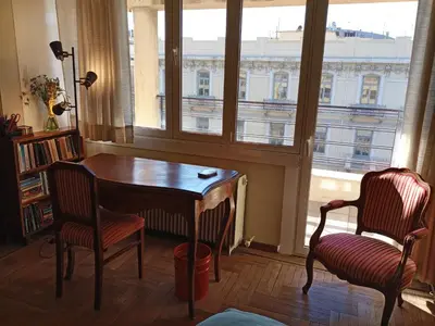 a room with a table and two chairs and a window at Park View Penthouse in Athens