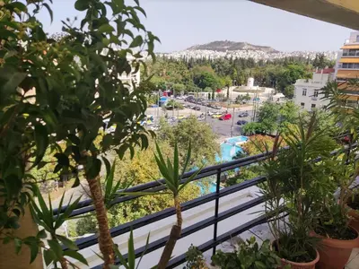 a balcony with plants and a view of a city at Park View Penthouse in Athens