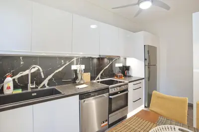 a kitchen with white cabinets and stainless steel appliances at Afrodite Classic Residence, 2BR, WiFi, City View in Athens