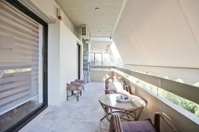 a balcony with chairs and a table and a window at Afrodite Classic Residence, 2BR, WiFi, City View in Athens