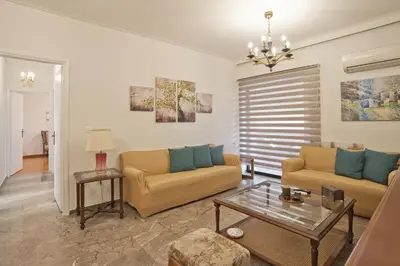 a living room with two couches and a table at Afrodite Classic Residence, 2BR, WiFi, City View in Athens