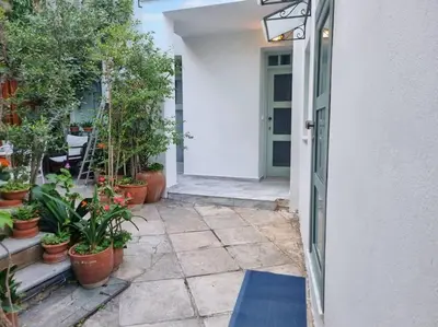 an entrance to a house with potted plants at Lemon Tree House with garden in Plaka in Athens