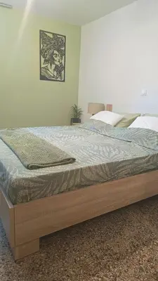 a bed with a wooden frame in a bedroom at Edem apartments in Athens