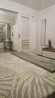 a bedroom with a bed with a zebra pattern on it at Edem apartments in Athens