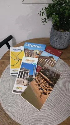 a table topped with magazines on top of a table at Edem apartments in Athens