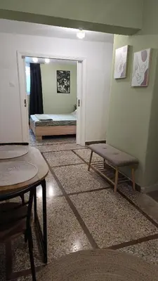 a room with a bedroom with a bed and a table at Edem apartments in Athens