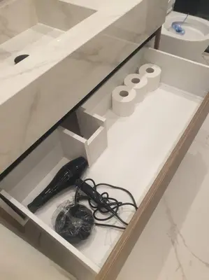 a white counter with a drawer with a charger and a cord at EcoStay Celebrity 2 BDR luxurious apartment by the sea# in Athens