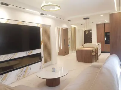a living room with a large flat screen tv on a wall at EcoStay Celebrity 2 BDR luxurious apartment by the sea# in Athens
