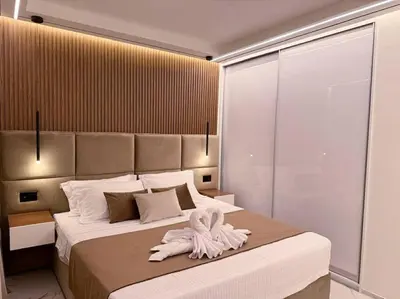 a bedroom with a large bed with towels on it at EcoStay Celebrity 2 BDR luxurious apartment by the sea# in Athens