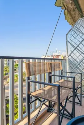 a chair sitting on top of a balcony at Three-Bedroom Elegant City Living in Athens