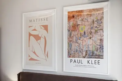 two framed posters on a wall in a room at Three-Bedroom Elegant City Living in Athens