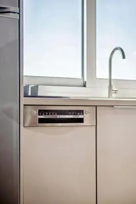 a kitchen with a stainless steel refrigerator and a sink at Three-Bedroom Elegant City Living in Athens