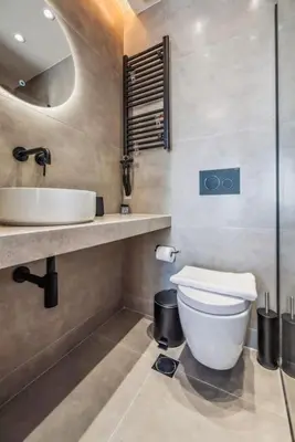 a bathroom with a white toilet and a sink at Three-Bedroom Elegant City Living in Athens