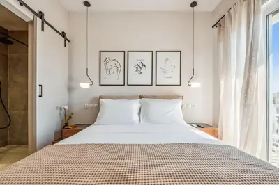 a bedroom with a large bed with two pillows at Three-Bedroom Elegant City Living in Athens