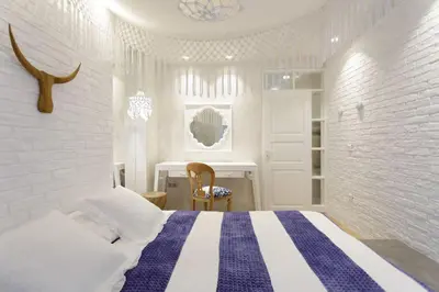 a white and blue bedroom with a bed and a desk at Stylish, Quiet & Relaxing, a Hidden Gem near the Acropolis in Athens