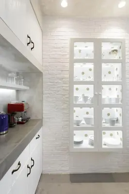 a kitchen with white cabinets and a shelf with dishes at Stylish, Quiet & Relaxing, a Hidden Gem near the Acropolis in Athens