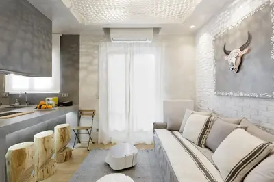 a living room with a couch and a kitchen at Stylish, Quiet & Relaxing, a Hidden Gem near the Acropolis in Athens