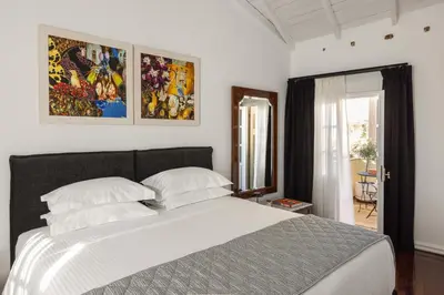 a bedroom with a large white bed with two pillows at House of Andele in Athens