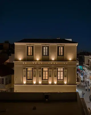 a building with lights on top of it at night at House of Andele in Athens