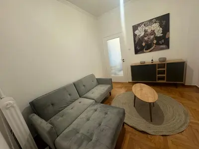 a living room with a couch and a table at Zografou centre apartment in Athens