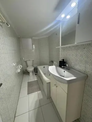 a white bathroom with a sink and a toilet at Zografou centre apartment in Athens
