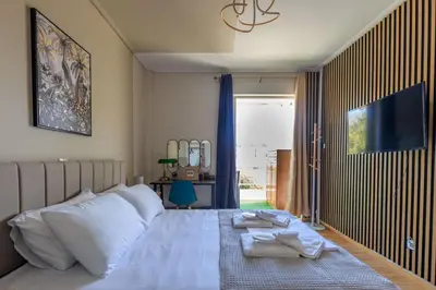 a bedroom with a bed with two towels on it at AIOLOS elegant escapes GLYFADA apartment in Athens