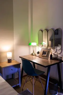 a room with a desk with a chair and mirrors at AIOLOS elegant escapes GLYFADA apartment in Athens