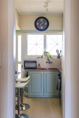 a kitchen with a clock on the wall above a counter at AIOLOS elegant escapes GLYFADA apartment in Athens