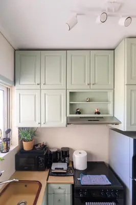 a kitchen with green cabinets and a stove top oven at AIOLOS elegant escapes GLYFADA apartment in Athens