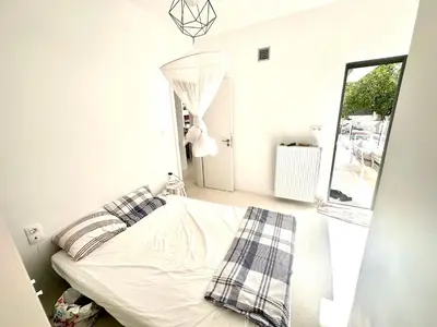 a bedroom with a bed in a room with a window at Luxury 6 bedroom 4 bathroom villa with pool in Vari