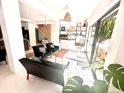 a living room with black furniture and a large window at Luxury 6 bedroom 4 bathroom villa with pool in Vari