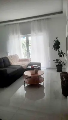 a living room with a couch and a coffee table at Penelope's in Athens