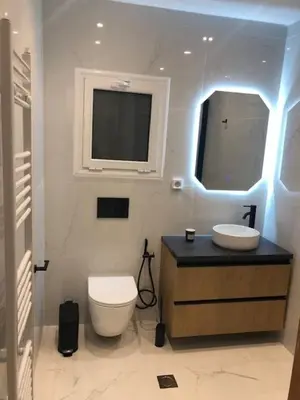 a bathroom with a toilet and a sink and a tv at Penelope's in Athens