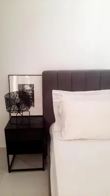 a bedroom with a bed and a nightstand next to a bed sidx sidx sidx at Penelope's in Athens