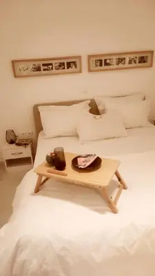 a white bed with a tray on top of it at Penelope's in Athens