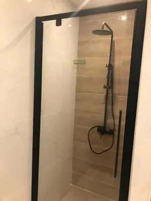 a shower with a shower head in a bathroom at Penelope's in Athens