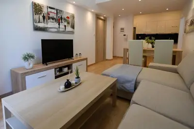 a living room with a couch and a tv at 2BR Apartment next to the Metro station in Athens