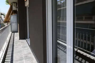 a balcony of a building with a window at 2BR Apartment next to the Metro station in Athens