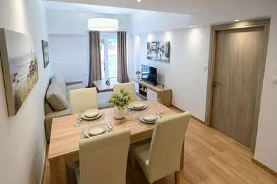 a dining room with a wooden table and chairs at 2BR Apartment next to the Metro station in Athens