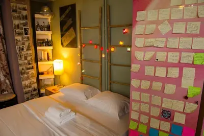 a bedroom with a pink wall with a bed at 500Mbps WiFi Budget Studio 1min from Attiki metro station in Athens