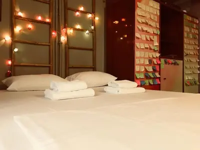 a bed with two towels on top of it at 500Mbps WiFi Budget Studio 1min from Attiki metro station in Athens