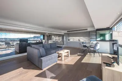 a living room with a couch and a table at Unique Acropolis View Apartment in Athens