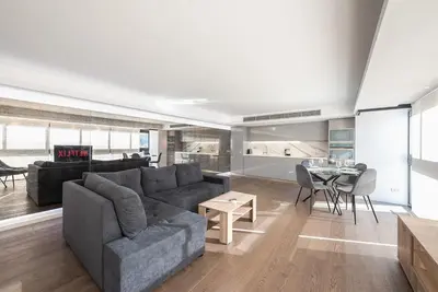 a living room with a couch and a table at Unique Acropolis View Apartment in Athens