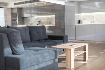 a living room with a couch and a coffee table at Unique Acropolis View Apartment in Athens