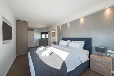 a bedroom with a large bed and a television at Unique Acropolis View Apartment in Athens