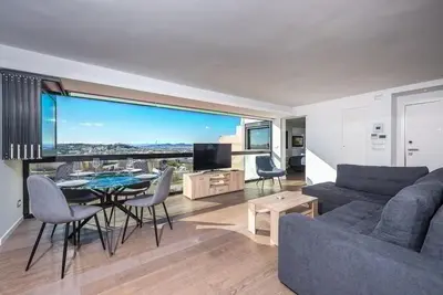 a living room with a couch and a table at Unique Acropolis View Apartment in Athens