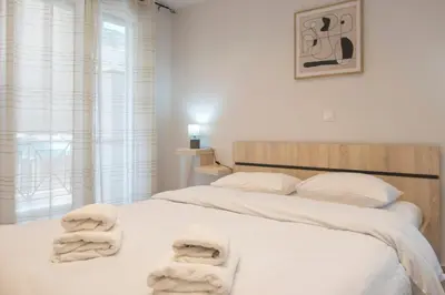 a bedroom with two beds with towels on them at Koukaki Sofia's Apartment in Athens