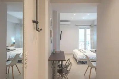 a bedroom with a bed and a table and chairs at Koukaki Sofia's Apartment in Athens